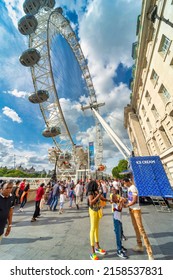 Lonon,England,UK-August 21 2019: Visitors enjoy the warm,sunny weather,at the Millennium Wheel,outside County Hall, on the South Bank of theThames,on a glorious summer day.