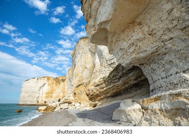 look up angel of the white towering sea cliff with blue sky in Étretat - Powered by Shutterstock