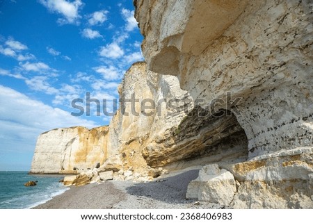 look up angel of the white towering sea cliff with blue sky in Étretat