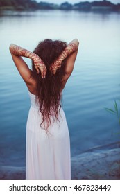 Look From Behind At A Woman Shaking Her Long Curly Hair