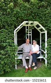 The look of Devotion. Active healthy couple in their eighties married for over 60 years sitting on love seat