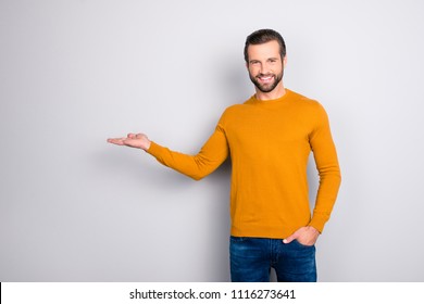 Look here! Attention! Portrait of handsome cheerful excited satisfied confident marketer wearing casual outfit keeping hand in pocket demonstrating empty place on his palm isolated on gray background - Powered by Shutterstock