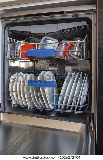 Look into dishwasher with the clean\
dish. Clean plate placed in kitchen cleaning\
machine