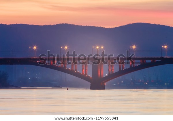 Look on on the\
bridge through the Yenisei River in Siberia, Russia, shooting at\
night, noise, soft focus