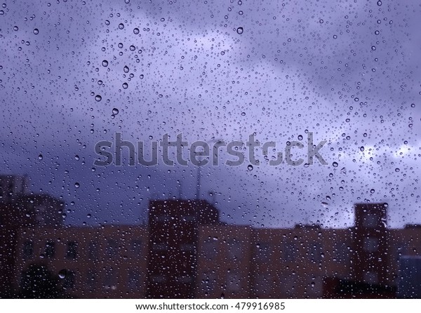 Look on rain at city through wet window glass stock\
photo 