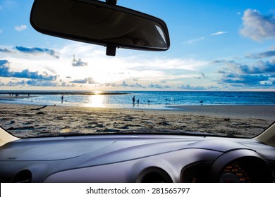 Look Out The Car Window To See The Sunset On The Beach For Use As A Background.