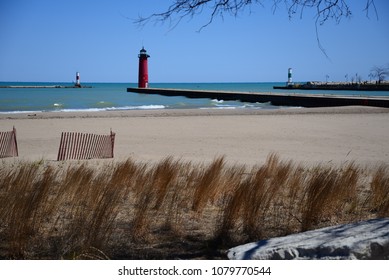 A look out to the lighthouse at the end of the peer in Kenosha Wisconsin along the shore of Lake Michigan.  Entrance with port and starboard markers. 