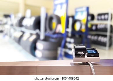 Look Out From The Payment Counter, Blur Image Of Tire Shop As Background.
