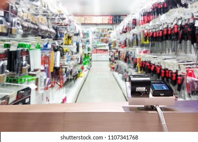 Look Out From The Payment Counter, Blur Image Of Tools Shop As Background.