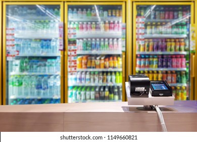 Look Out From The Payment Counter, Blur Image Of Beverage Cooler Inside The Convenience Store As Background.