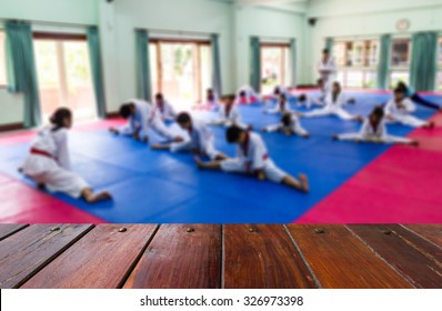 Look Out From The Wood Table, The Blurring Of The Children Are Learning Taekwondo .
