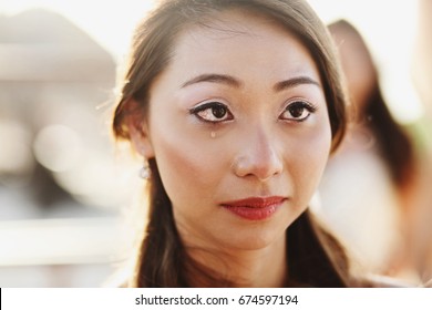 Look Over Groom's Shoulder At Happy Crying Bride