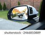 Look in the rear view mirror of a car. Look in the rear view mirror of car.