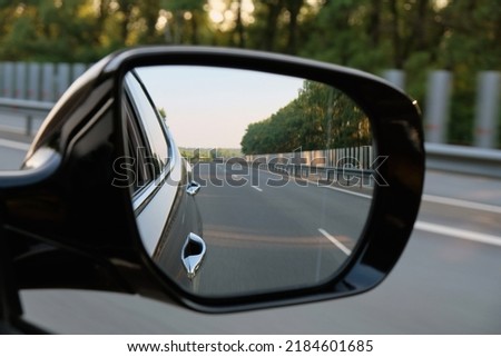 look in the rear view mirror of a car