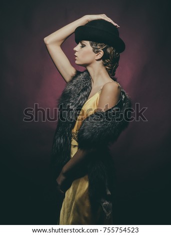 Look and retro style, pinup. Pin up pretty fashion model pose on burgundy background. Woman with stylish retro hair and makeup. Girl in fashionable yellow dress, hat, fur. Beauty and vintage fashion.