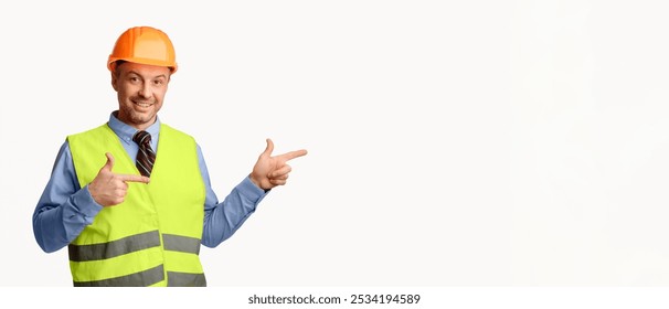Look There. Construction Worker Pointing Fingers Aside At Empty Space For Text Posing On White Studio Background. Panorama
