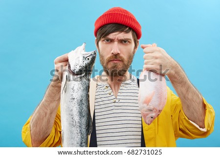 Image, Stock Photo Angler holds dead fish in his hand