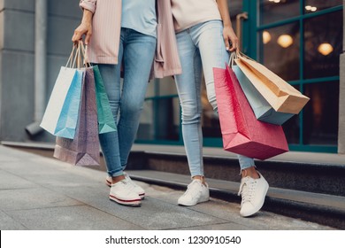 Look what we got. Cropped portrait of young lady and her mother holding colorful shopping bags - Shutterstock ID 1230910540
