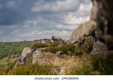 Looking Along The Cliff Edge Of Curbar Edge, A Natural Formed Edge In The Peak District National Park. This Valley Was Created By Glaciers In The Last Ice Age But Now Is Full Of Trees And Plants.