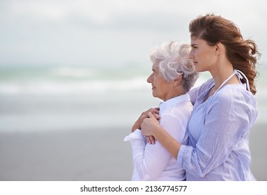 Looking back on their love-filled years together. Shot of a beautiful young woman and her senior mother on the beach. - Powered by Shutterstock