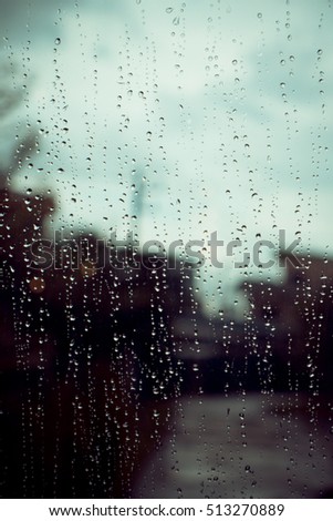 Looking at the beautiful rain drops out side the window abstract art background. Vintage Tone