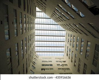 Looking up to the bright light sky through modern quardrilateral ceiling window
