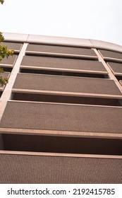 Looking Up At A Building From A City Sidewalk