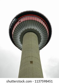looking up at the calgary tower on a cloudy day in calgary, alberta,  canada