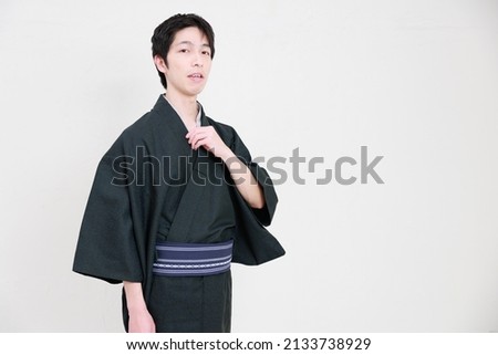 Looking at the camera of a man wearing a kimono
