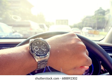 Looking at the clock while driving because of hustle to work.