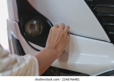 Looking At A Damaged Vehicle. Woman Inspects Car Damage After An Accident Car Paint