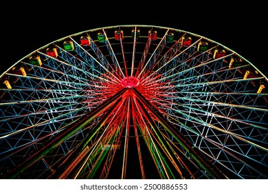 Looking up at a dazzling Ferris wheel, its lights create a vibrant display against the night sky. The colorful design and dynamic structure evoke excitement and joy, captivating all who see it. - Powered by Shutterstock