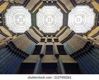 Looking Up At The Different Colors Of Brick And Glass Ceiling In The Peter Behrens Building At The Hoescht Industrial Park Outside Of Frankfurt, Germany