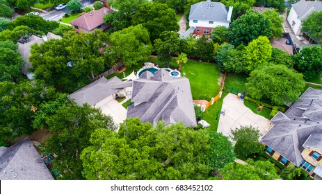 Looking down from above Texas hill country homes green trees and green grass with lots of privacy and luxury architecture nice homes in nice suburb