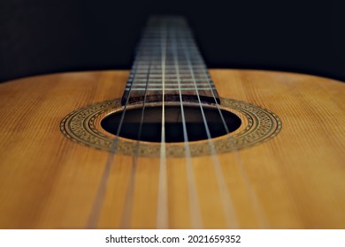 Looking down an acoustic guitar, strings, fretboard