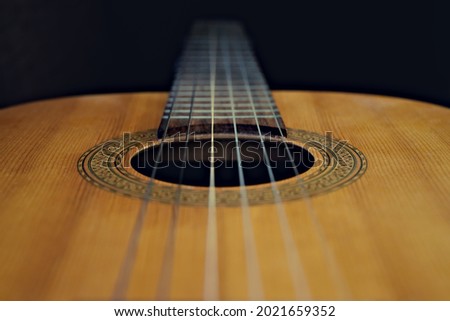 Looking down an acoustic guitar, strings, fretboard