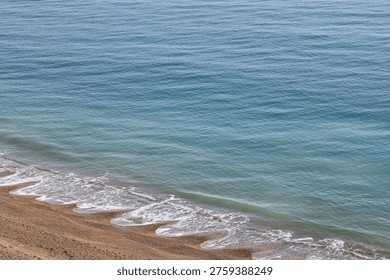 Looking down at beach cusps along the Jurassic coast, on a sunny day