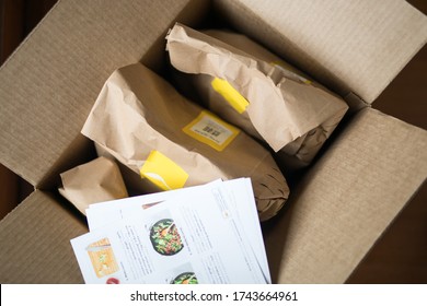 Looking Down At A Brown Deliveyr Box Filled With Ingredients Required To Prepare Own Meals With Directions Recipe Card