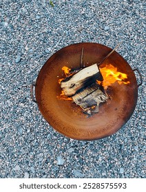Looking down at a burning fire pit.