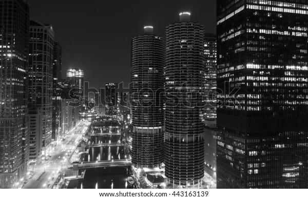 Looking down the Chicago River at night in\
Chicago, Illinois in black and\
white.