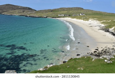Looking down at clear turquoise waters at a deserted beach on Harris.