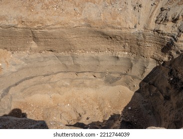 Looking Down A Hoe Dug Into The Sant On A Beach.