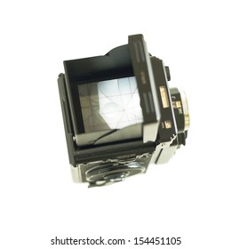Looking down into the view finder of an old medium format film camera (twin lens reflex) isolated on white. View of studio light on stand with umbrella diffuser.