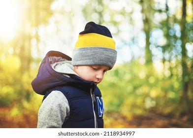 Looking down little boy. Horizontal outdoors shot - Shutterstock ID 2118934997