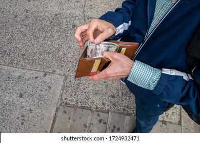 Looking Down At A Man With Open Wallet Ready To Spend Some US Cash Currency Money Five Dollar Bill