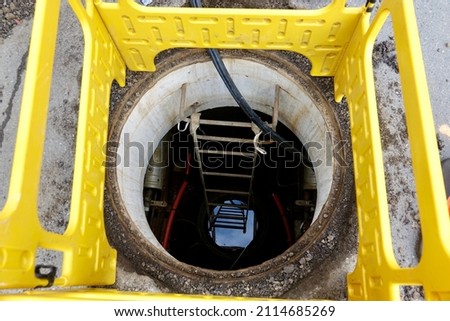 looking down a manhole into a cable vault