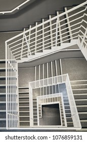 Looking Down At A Modern Staircase With White Wall As To Be Found In An Office, Hospital Or An Apartment.