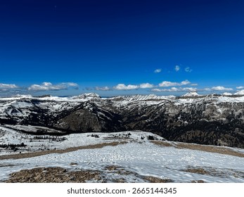 Looking down Mount Rendezvous at the snow covered mountains of the Teton Range in early Autumn