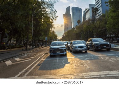 Looking down a multi-lane downtown road with oncoming cars at dusk.