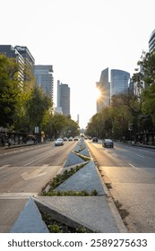 Looking down a multi-lane downtown road with cars at dusk.